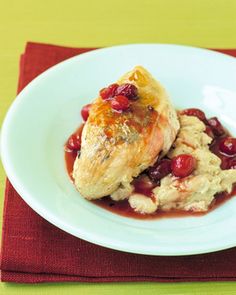 a white plate topped with meat covered in cranberry sauce