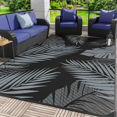 an outdoor area rug with blue and black furniture