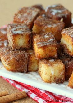 a pile of cinnamon sugar cubes sitting on top of a white plate