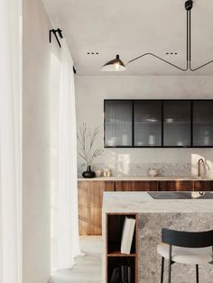 a modern kitchen with marble counter tops and bar stools next to the sink area