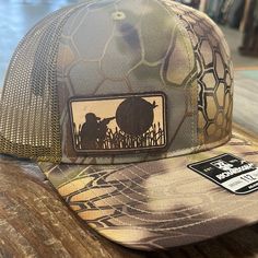 The Mud Duck Cap/Hat DUCK HUNTING LEATHER CUT ON KRYPTEK CAMO RICHARDSON SNAP The original Richardson Adjustable Trucker Hat MUD-KR-S Brown Military Hat For Hunting, Brown Hunting Cap, Brown Hunting Hat With Leather Patch, Brown Leather Patch Hunting Hat, Brown Flat Bill Hat For Hunting, Brown Flat Bill Hunting Hat, Brown Snapback Hat For Hunting, Brown Snapback Trucker Hat For Hunting, Brown Snapback Cap For Hunting