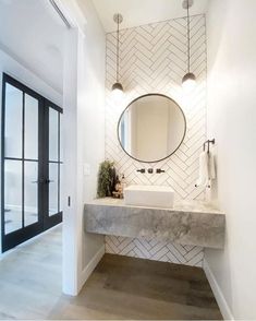 a bathroom with a marble sink and mirror