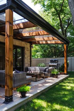 an outdoor living area with couches, chairs and a grill in the back yard