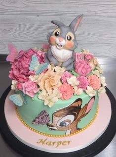 a cake decorated with an image of a rabbit and flowers