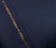 there is a close up view of the zipper on a blue suit with gold lettering