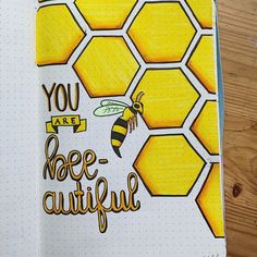 an open notebook with the words you are bee - awful on it and a drawing of a honeycomb