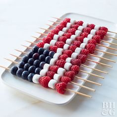 an american flag made out of berries and marshmallows on a white plate