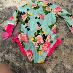 Questions? Leave A Comment Below! Multicolor Spring Bodysuit For Playwear, Spring Multicolor Bodysuit For Playwear, Floral Print Swimwear For Spring Playwear, Cute Swimwear For Spring Playwear, Fun Pink Onesie For Spring, Fun Pink Spring Onesie, Playful Pink Bodysuit For Pool, Cute Blue Bodysuit For Swimming, Cute Blue Swimming Bodysuit