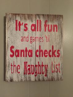 a wooden sign that says it's all fun and games til santa checks the naught list