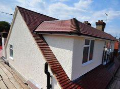 a white house with a red tiled roof