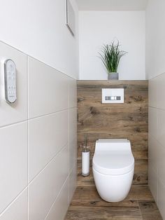 there is a toilet in the bathroom with wood paneling on the walls and floor