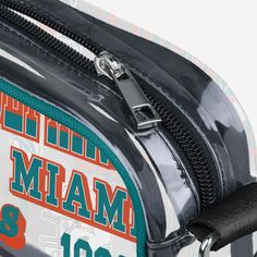 Over your shoulder and off to the game. Whether you're running errands on the town or running the tailgate in the parking lot, this Miami Dolphins Repeat Retro Print Clear Crossbody Bag is the perfect way to carry the team like never before. Features Repeat Miami Dolphins current and retro team logo and wordmark displays on sides of bag, in case there were any doubts where your allegiances lie Woven, team-colored crossbody strap that makes carrying the team easy and convenient Repeat team wordma Functional Rectangular College Bags, Functional Rectangular College Bag, Eagles Kelly Green, Eagles Team, Retro Print, Miami Dolphins, National Football League, Parking Lot, Football League