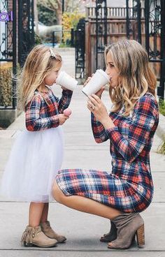 mother and daughter drinking coffee on the sidewalk