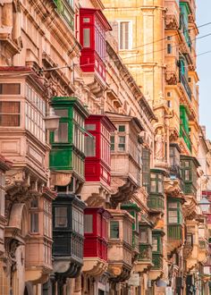 a row of buildings with balconies on the windows