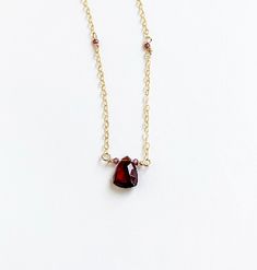 Small and dainty, but oh so pretty. The focal garnet is a pyramid trillion and catches the light. Faceted garnets round out the necklace. + Garnets. 14K Gold Fill Spring Ring Clasp & Chain. + Length: 17.5 inch. + Necklace is ready to ship. + Your jewelry will come in a jewelry box, tied with a ribbon. Red Gemstone Necklace, Garnet Necklace, Red Necklace, Necklace Red, Red Gemstones, Silver Jewelry Handmade, Holiday Jewelry, Minimalist Necklace, Delicate Necklace