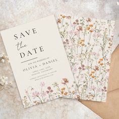 wedding save the date cards with flowers and leaves on them next to an envelope that says save the date