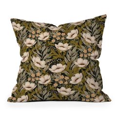 a green pillow with white flowers on it