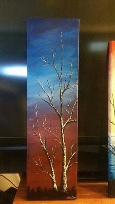 two canvases with trees painted on them