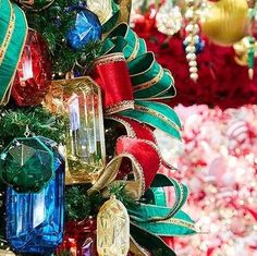 a christmas tree decorated with ornaments and ribbons