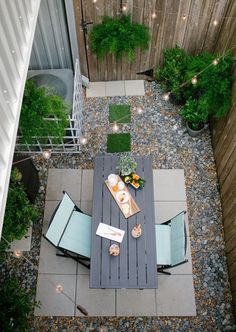 an overhead view of a patio with table and chairs