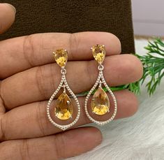 This Earring is made from  Natural Yellow Citrine and 925 sterling silver. This Dangle Earring is finely polished to give a brilliant mirror finish. With rejuvenating design and sleek appearance, this Earrings looks stunning on Ear Material :- (Silver) 925 Solid Sterling Silver Gemstone :- Natural Citrine Item Weight :- 6 Grams Approx. Stone Size :- 8x12 MM  Stone Shape :- Pear Cut Secondary Stone :- Natural Citrine Stone Size & Shape :- 6x9 MM Pear Cut Payment Policy :-  We accept payment throu Citrine Jewelry, Yellow Gemstones, Yellow Citrine, Citrine Stone, Natural Citrine, November Birthstone, Pear Cut, Teardrop Earrings, Designer Earrings