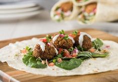 falafel on a tortilla with lettuce and tomatoes