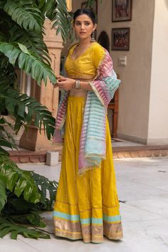 Yellow chanderi blend lehenga with gota, sequin work panel details and border. Paired with embroidered back tie-up blouse and ombre gota work stripes dupatta with fringe lace border.
Component: 3
Pattern: Embroidered
Type Of Work: Gota and Sequin Work
Neckline: V Neck
Sleeve Type: Half Sleeves
Fabric: Chanderi Blend
Color: Yellow
Other Details: 
Back tie-up belt, hook and eye closure on blouse
Occasion: Sangeet,Haldi and Mehendi - Aza Fashions V Neck Lehenga, Gota Work, Belt Hook, Embroidered Lehenga, Lace Border, Set For Women, Aza Fashion, Sleeve Type, Half Sleeves