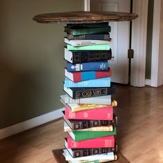 a stack of books sitting on top of a hard wood floor next to a door