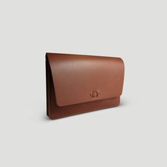 "Introducing our first women's all-in-one clutch & wallet.  This full grain English bridle accessory intended for everyday use or special occasions. With two large and two small compartments, it can fit anything from a passport, phone, makeup, and credit cards -- with room to spare. It has a slim minimal design with a unique hidden snap closure. Dimensions: Length: 8 3/4\" Height: 6\" Depth: 3/8\" flat, 2.5\" full We make it easy to be green. We use U.S. sourced vegetable tanned leather. This me Classic Brown Clutch For Everyday Use, Timeless Wallets With Card Slots For Everyday Use, Classic Clutch With Smooth Grain For Daily Use, Classic Business Clutch With Leather Lining, Classic Brown Clutch With Leather Lining, Classic Envelope Clutch For Travel, Classic Clutch With Leather Lining For Everyday Use, Classic Clutch With Card Slots, Classic Everyday Envelope Clutch