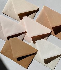 several envelopes are lined up on top of each other, with one being folded