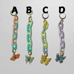 four different types of key chains with butterfly charms on each side and the letters abcd above them