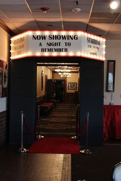 a sign that says now showing at night to remember