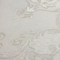 close up view of white fabric with floral design