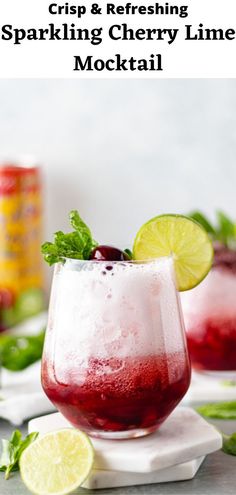 two glasses filled with liquid and garnished with limes