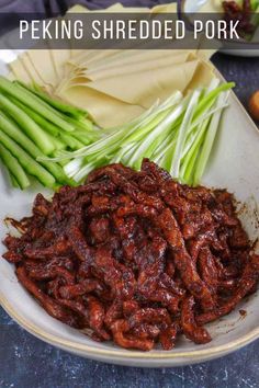 there is a white plate with food on it and the words peking shredded pork