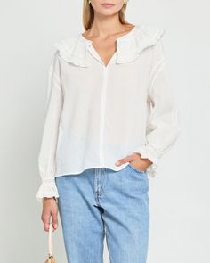 Product Details The Kalliope Top features a peasant sleeve with a delicate ruffle and a ruffled collar accented with lace detailing. The front button at the neck allows for versatile styling options, while the breezy fabric ensures comfort. Elevate your wardrobe with this feminine and versatile top. - Front button- Content: 100% Cotton Style# C23WTP06039 Fit Notes - Model wearing a size XS - Model measurements: 5'10'' Height / 32'' Bust / 24'' Waist / 34'' Hips- Garment measurements: Size Length