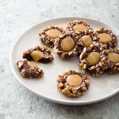 several cookies with peanut butter on a white plate