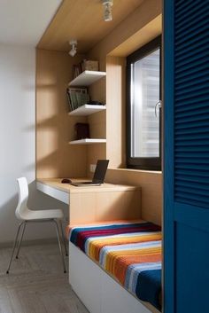 a room with a bed, desk and shelves