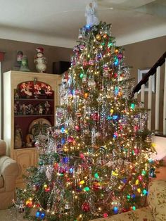 a brightly lit christmas tree in a living room