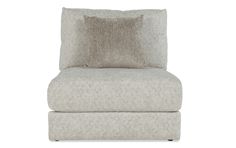 a beige chair with two pillows on it's back and the seat upholstered