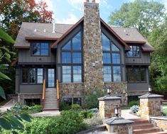 a large house with lots of windows and steps leading up to the front porch area