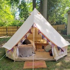 a teepee tent is set up in the yard