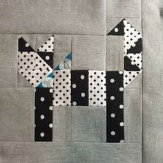 the block is made up of black and white polka dots with a dog on it