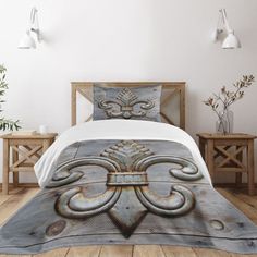 an image of a bed in a room with white walls and wood flooring on it