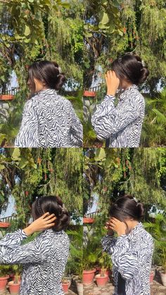 a woman in zebra print shirt holding her hands to her face while standing next to potted plants