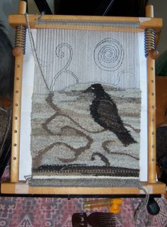 a weaving machine with a bird on it