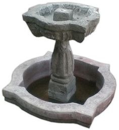 a stone fountain with two rocks in it