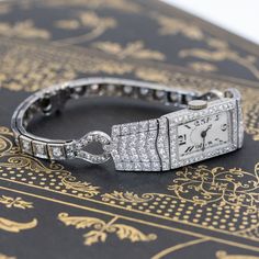 One of the most beautiful, blingy, and absolutely stunning cocktail watches that one could possibly add to one's jewelry suite! Made by the well-known jewelry house JE Caldwell, the watch is studded with antique diamonds, pave-set in platinum. The case is in excellent condition and has been observed to be running. The bracelet is in addition, styled beautifully to complement the case. The perfect accessory to complete any outfit! Platinum with a 14kt white gold bracelet Will fit up to a 6.25" wr Modern Mens Rings, Art Jewelry Earrings, Art Deco Watch, Bespoke Rings, Antique Watches, White Gold Bracelet, Antique Engagement, Antique Engagement Rings, Art Deco Diamond