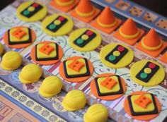 there are many decorated cookies in the shape of traffic lights on this board game table