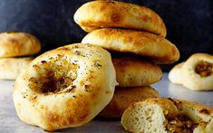 a pile of bagels sitting next to each other on top of a countertop